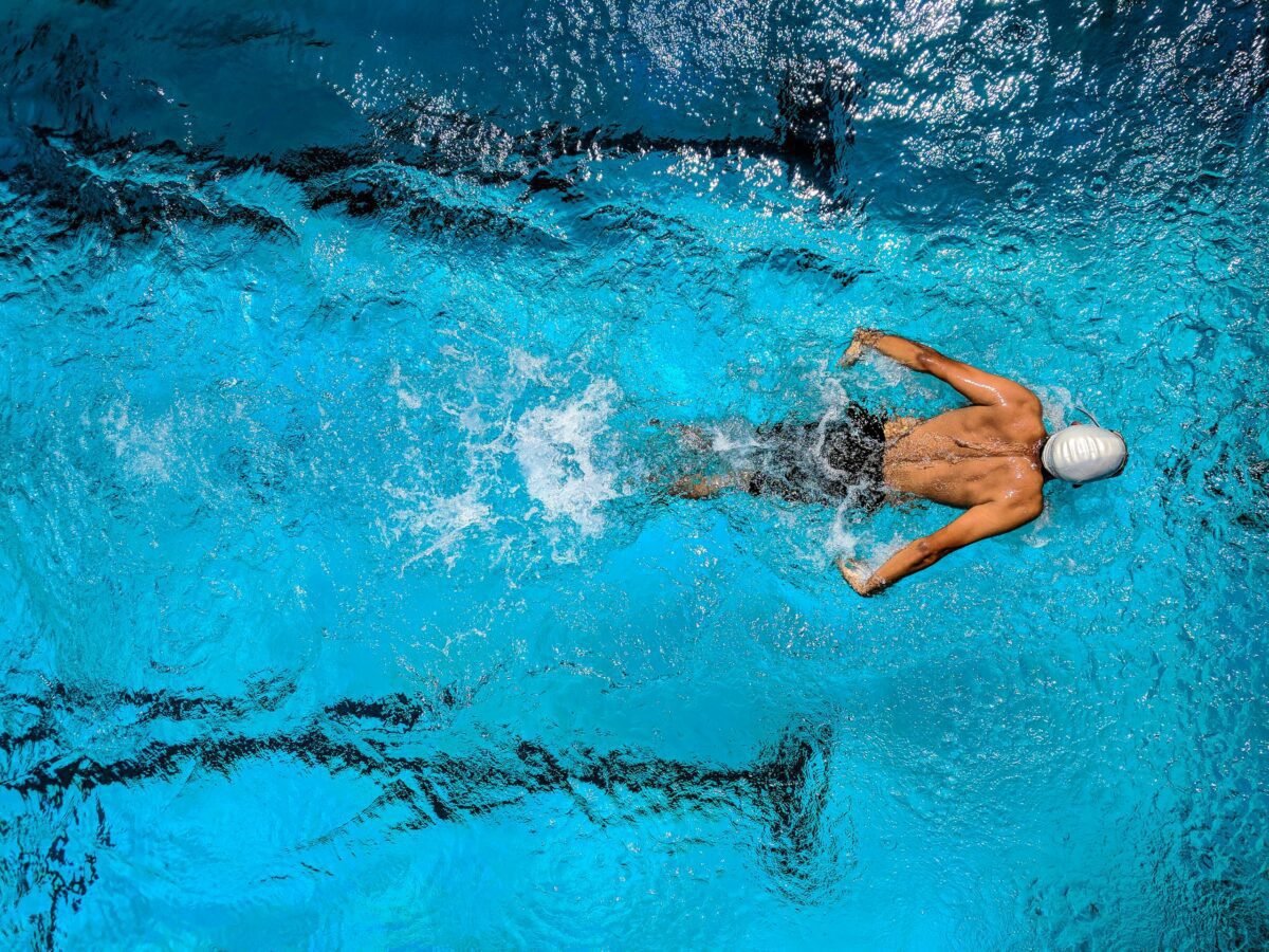 Person Swimming on Body of Water